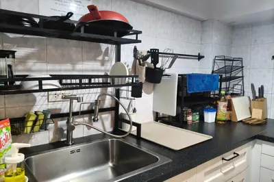 a kitchen with a sink and a counter top at El Biografo in Bangkok