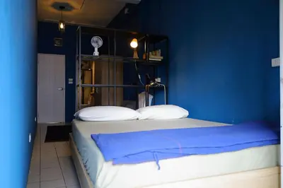 a blue bedroom with a bed with blue walls at El Biografo in Bangkok