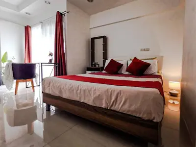 a bedroom with a large bed with red pillows at Tower Resident in the Heart of Bangkok Shopping Center in Makkasan