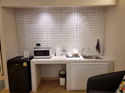 a kitchen with a counter with a microwave and a sink at Better Room ห้องพักรายวัน เมืองทองธานี C5 in Nonthaburi
