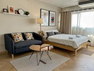 a bedroom with a bed and a couch at Better Room ห้องพักรายวัน เมืองทองธานี C5 in Nonthaburi