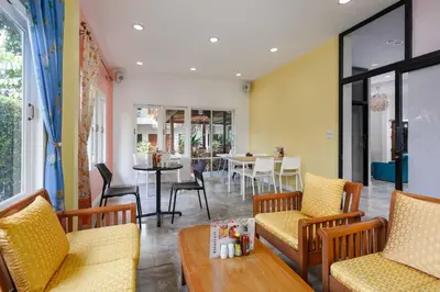 a living room with two chairs and a table at Charlie House Pin Klao in Bangkok