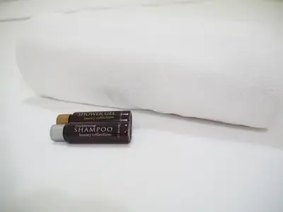a stick of lipstick sitting on top of a white bed at NANA BEST INN HOTEL in Makkasan