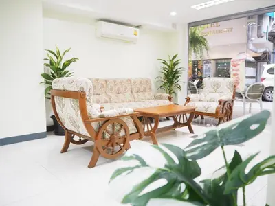 a living room with two chairs and a coffee table at NANA BEST INN HOTEL in Makkasan