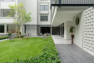 an internal courtyard of a building with a green lawn at Pranakorn Heritage Hotel in Bangkok