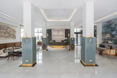 a lobby of a hotel with tables and chairs at Pranakorn Heritage Hotel in Bangkok