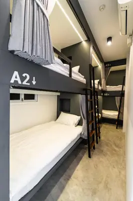 a dorm room with two bunk beds in it at PIER 808 Hostel in Bangkok