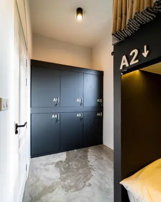 a room with a bunch of lockers in a room at PIER 808 Hostel in Bangkok