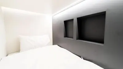 a bedroom with a bed and two television at PIER 808 Hostel in Bangkok