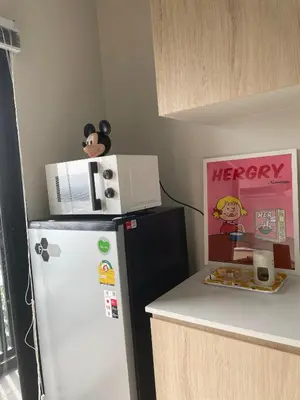 a kitchen with a refrigerator and a microwave on top of it at N Condominium in Ban Bang Khen (1)
