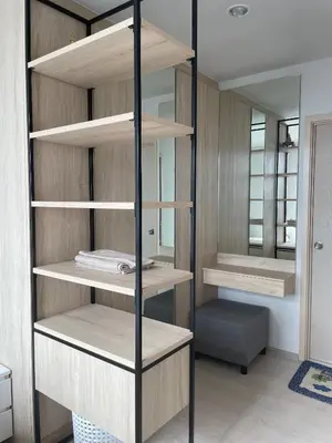 a room with wooden shelves and a mirror at N Condominium in Ban Bang Khen (1)