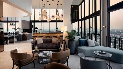 a living room with a blue couch and chairs at N Condominium in Ban Bang Khen (1)