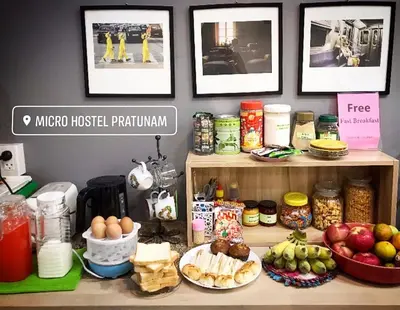 a counter with many different food items on it at Micro Hostel in Bangkok