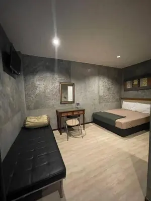 a bedroom with a bed and a desk in it at BKK TEAK Hostel in Amphoe Phra Khanong