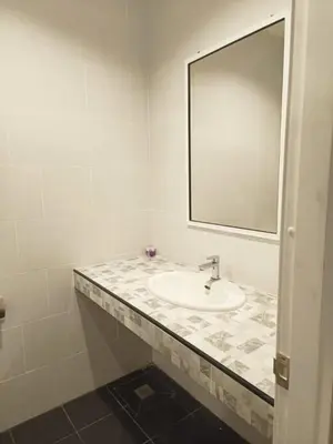 a bathroom with a sink and a mirror at BKK TEAK Hostel in Amphoe Phra Khanong