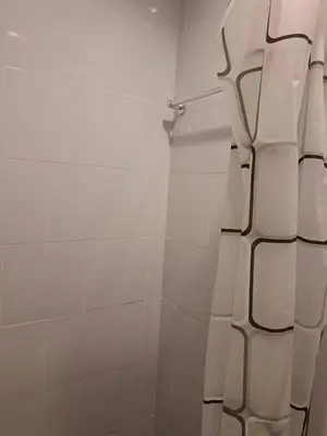 a bathroom with a shower with a shower curtain at BKK TEAK Hostel in Amphoe Phra Khanong