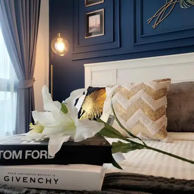 a room with a bed with a book and a flower at KnightsBridge BTS Bearing in Ban Khlong Samrong