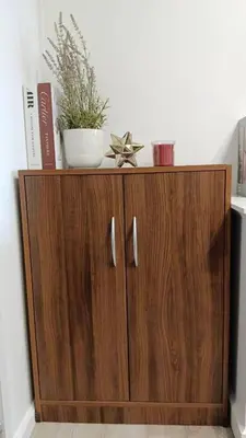 a wooden cabinet with a plant on top of it at KnightsBridge BTS Bearing in Ban Khlong Samrong