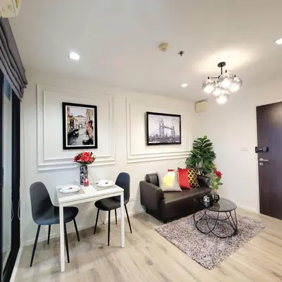 a living room with a couch and a table at KnightsBridge BTS Bearing in Ban Khlong Samrong