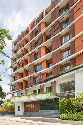 an apartment building with orange and white at Tierra Residences in Bangkok
