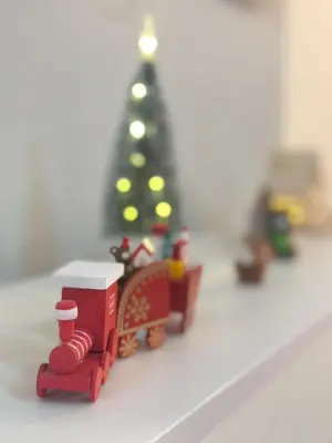 a toy train with a christmas tree in the background at NK hostel 31 in Ban Bang Phang