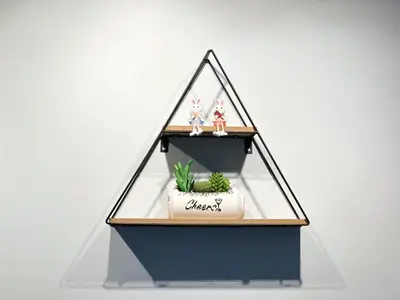 a glass pyramid shelf with a plant in it at NK hostel 31 in Ban Bang Phang
