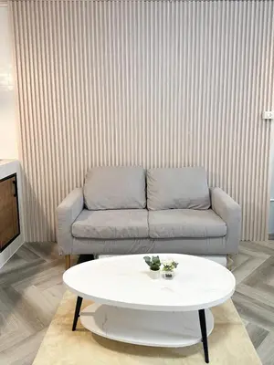 a living room with a couch and a table at NK hostel 31 in Ban Bang Phang