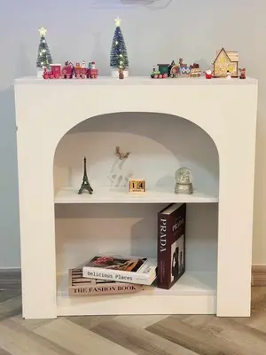 a white book shelf with books and christmas decorations at NK hostel 31 in Ban Bang Phang