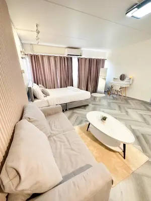 a living room with a couch and a table at NK hostel 31 in Ban Bang Phang