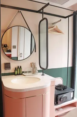 a bathroom with a sink and a mirror at The Quarter Ratchathewi by UHG in Bangkok