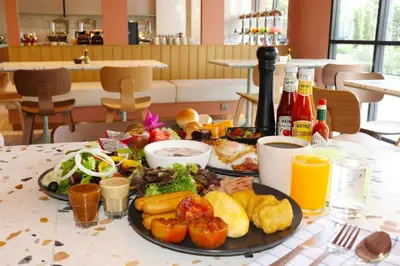 a table with two plates of food on it at The Quarter Ratchathewi by UHG in Bangkok
