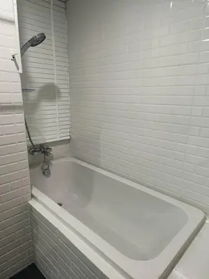 a white bath tub in a bathroom with a shower at โรงแรมแอเรียเพลส สาทร (AREA Place) in Chong Nonsi