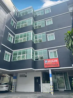 a building with a no smoking sign in front of it at Metro Link Ratchada Hotel in Bangkok