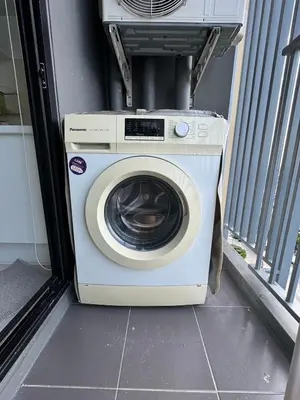 a washing machine sitting inside of a house at Near central westgate at bangyai 80 in Ban Bang Krabu