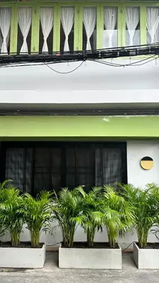 a row of plants in front of a building at The Tangerine Guesthouse in Bangkok