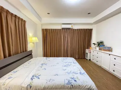 a bedroom with a bed and a dresser and a window at Modern 5-Bedroom Townhome near MRT and Local Charm in Bangkok