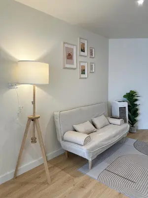 a living room with a couch and a lamp at Happiness sleep C3 in Ban Bang Phang