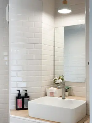 a white bathroom with a sink and a mirror at Happiness sleep C3 in Ban Bang Phang