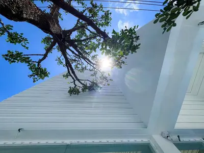 a staircase leading up to the sky from a house at Matini Hostel grandstation in Bangkok