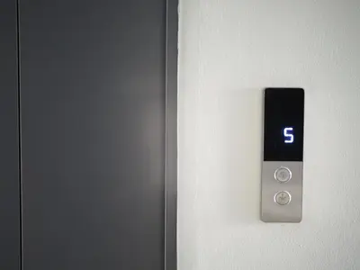 a button on a door with the number six on it at Krung Tone Hostel in Bangkok