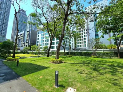 a park with trees and buildings in a city at Floral Court Hotel & Residence Sukhumvit 13 in Bangkok