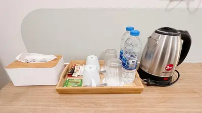 a wooden tray with a blender and bottles of water at La Moon House in Salaya