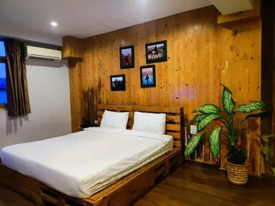a bed in a room with a wooden wall at mstay in Bangkok