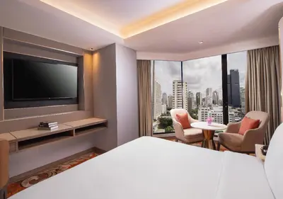 a hotel room with a bed and a flat screen tv at SAMALA Hotel Bangkok in Bangkok