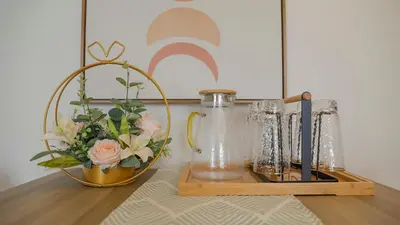 a wooden shelf with vases and a vase with flowers at Funstay Bangkok Circle Condo in Bangkok