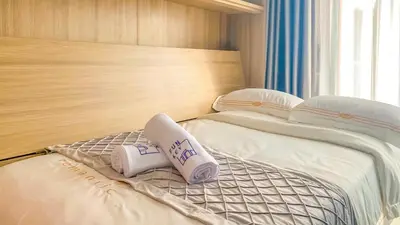 two beds in a hotel room with pillows on them at Funstay Bangkok Circle Condo in Bangkok