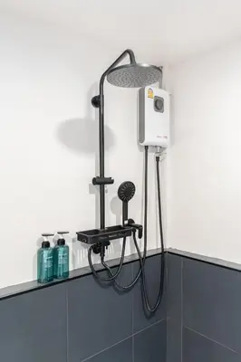 a shower in a bathroom with a blow dryer at The Mellow at Ekkamai in Bangkok