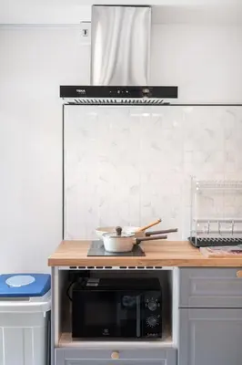 a kitchen with a counter top with a microwave at The Mellow at Ekkamai in Bangkok