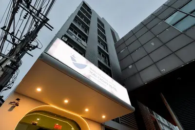 a sign for a apple store in front of a building at Tori crown hotel in Bangkok