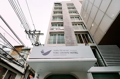 a sign in front of a tall building at Tori crown hotel in Bangkok